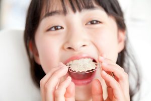 矯正装置を口の中に入れようとしている子供